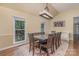 Elegant dining room with a long wooden table, stylish chandelier, and sunlit windows at 140 Rustic Way Ln, Mooresville, NC 28117
