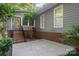 Home exterior featuring a brick staircase leading to the front door, surrounded by trees and landscaping at 140 Rustic Way Ln, Mooresville, NC 28117