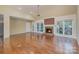 Spacious living room with a cozy brick fireplace, wood floors, and bright windows at 140 Rustic Way Ln, Mooresville, NC 28117