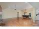 Open-concept living space with a fireplace, dining area, and beautiful hardwood floors at 140 Rustic Way Ln, Mooresville, NC 28117