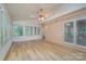 Inviting sunroom with wood floors, ample natural light, neutral walls, and a ceiling fan at 140 Rustic Way Ln, Mooresville, NC 28117