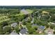 A residential area offers mature trees, well-maintained homes, a lake, and a golf course for a picturesque community setting at 14103 Hiawatha Ct, Huntersville, NC 28078