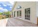 A spacious back deck adjoins the home with multiple windows and a door to access the backyard at 14103 Hiawatha Ct, Huntersville, NC 28078