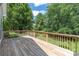A wooden back deck overlooks the backyard and is shaded by mature trees, offering serene outdoor living space at 14103 Hiawatha Ct, Huntersville, NC 28078