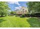 Expansive backyard with lush greenery and a wooden deck, perfect for outdoor enjoyment and entertaining at 14103 Hiawatha Ct, Huntersville, NC 28078