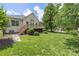 Large backyard featuring a well-maintained lawn, a wooden deck, and mature landscaping at 14103 Hiawatha Ct, Huntersville, NC 28078