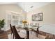 Bright dining room featuring a glass table, chandelier, and a large bay window at 14103 Hiawatha Ct, Huntersville, NC 28078