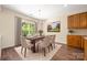 Dining room with wood floors and a view of the backyard through a large window at 14103 Hiawatha Ct, Huntersville, NC 28078