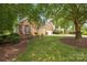 View of home with mature trees providing shade to the front yard of this home at 14103 Hiawatha Ct, Huntersville, NC 28078