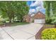 A charming brick home featuring a long driveway leading to an attached two-car garage at 14103 Hiawatha Ct, Huntersville, NC 28078