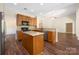 Bright kitchen with wood cabinets, stainless steel appliances, granite countertops, and wood-look flooring at 14103 Hiawatha Ct, Huntersville, NC 28078