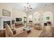 Spacious living room with fireplace, neutral decor, and arched doorways at 14103 Hiawatha Ct, Huntersville, NC 28078
