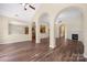 A large living room with hardwood floors, fireplace, and arched doorways at 14103 Hiawatha Ct, Huntersville, NC 28078