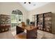 Bright office space with large arched window, hard wood desk, hardwood floors and built-in shelving at 14103 Hiawatha Ct, Huntersville, NC 28078