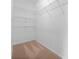 An empty walk-in closet featuring wire shelving and neutral carpeting, awaiting personal organization and storage solutions at 14103 Hiawatha Ct, Huntersville, NC 28078