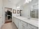 Bright bathroom with double vanity, granite countertops, large mirror and separate walk-in closets at 15614 Aviary Orchard Way, Charlotte, NC 28278