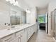 Bright, open bathroom with double vanity, marble countertops, and walk-in shower near bedroom at 15614 Aviary Orchard Way, Charlotte, NC 28278
