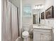 Clean bathroom featuring a toilet, vanity with sink, and a shower with a curtain at 15614 Aviary Orchard Way, Charlotte, NC 28278