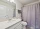 Well-lit bathroom includes a vanity, toilet, and shower with gray fixtures and accessories at 15614 Aviary Orchard Way, Charlotte, NC 28278
