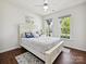 Bright bedroom with white furniture, ceiling fan, and two windows providing natural light at 15614 Aviary Orchard Way, Charlotte, NC 28278