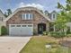 Charming stone and siding home with a two-car garage and inviting front yard at 15614 Aviary Orchard Way, Charlotte, NC 28278
