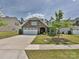 Inviting home with a manicured lawn, stone facade, and two-car garage on a sunny day at 15614 Aviary Orchard Way, Charlotte, NC 28278