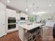 Well-equipped kitchen with stainless steel appliances, a central island, and an open layout at 15614 Aviary Orchard Way, Charlotte, NC 28278