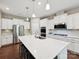 Modern kitchen with white cabinets, a large center island, and stainless steel appliances at 15614 Aviary Orchard Way, Charlotte, NC 28278