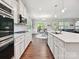 Modern kitchen featuring stainless steel appliances, white cabinets, and open layout at 15614 Aviary Orchard Way, Charlotte, NC 28278