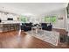 Open-concept living room with hardwood floors, a fireplace, and ample natural light at 15614 Aviary Orchard Way, Charlotte, NC 28278