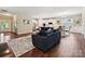 Spacious living room with a comfortable sofa, hardwood floors, and an open layout at 15614 Aviary Orchard Way, Charlotte, NC 28278