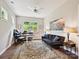 Home office with a large window, ceiling fan, modern furniture and a decorative area rug at 15614 Aviary Orchard Way, Charlotte, NC 28278