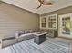 Covered patio featuring comfortable seating, a ceiling fan, and an outdoor rug for relaxation at 15614 Aviary Orchard Way, Charlotte, NC 28278