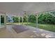 Covered back patio with ceiling fans overlooking a large backyard at 15724 Eagleview Dr, Charlotte, NC 28278