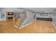 Spacious basement area featuring a wet bar, fireplace, and staircase with wrought iron railing at 15724 Eagleview Dr, Charlotte, NC 28278