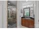 Beautiful bathroom featuring a glass enclosed shower and a dark wood vanity at 15724 Eagleview Dr, Charlotte, NC 28278