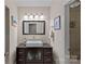 Bathroom vanity with black countertop, white sink, and walk-in shower at 15724 Eagleview Dr, Charlotte, NC 28278