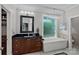 Stylish bathroom featuring a modern soaking tub, vanity, and elegant fixtures at 15724 Eagleview Dr, Charlotte, NC 28278