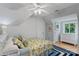 Cozy bedroom featuring a ceiling fan, wooden floors, and a dresser next to a window at 15724 Eagleview Dr, Charlotte, NC 28278