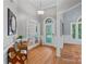 Bright foyer with hardwood floors, decorative mirror and glass paneled french doors at 15724 Eagleview Dr, Charlotte, NC 28278