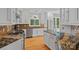 Open-concept kitchen featuring granite countertops, stainless appliances, and warm wood floors at 15724 Eagleview Dr, Charlotte, NC 28278