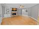 Inviting living room with stone fireplace, hardwood floors, and built-in shelving at 15724 Eagleview Dr, Charlotte, NC 28278