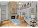 Grand living room with a soaring stone fireplace and an elegant wrought iron balcony at 15724 Eagleview Dr, Charlotte, NC 28278