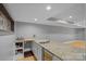 Basement wet bar boasts granite countertops, custom cabinets, and a stainless steel sink at 15724 Eagleview Dr, Charlotte, NC 28278