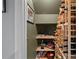A small wine cellar with wood shelving and room for storage with olive green walls at 15724 Eagleview Dr, Charlotte, NC 28278