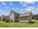 Spacious backyard, showcasing the property's exterior with deck under blue sky, perfect for recreation at 2040 Brantley Creek Dr, Kannapolis, NC 28083