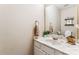 Clean half-bathroom featuring a marble countertop and decorative mirror at 2040 Brantley Creek Dr, Kannapolis, NC 28083
