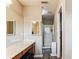 Modern bathroom with dual mirrors, a walk-in shower and luxury vinyl flooring at 2040 Brantley Creek Dr, Kannapolis, NC 28083