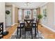 Sunlit dining room with hardwood floors, a large bay window, and a stylish dining table set at 2040 Brantley Creek Dr, Kannapolis, NC 28083