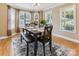 Bright dining room with hardwood floors, decorative rug, and a table set for a meal at 2040 Brantley Creek Dr, Kannapolis, NC 28083